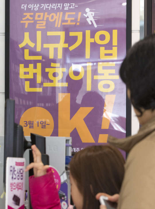 1일 오전 서울 종로구의 한  이동통신사 직영점에 주말에도 휴대전화 개통이 가능하다는 문구가 적힌 플랜카드가 붙어 있다.      미래창조과학부와 방송통신위원회는 지난 달 25일 SK텔레콤·KT·LG유플러스 등 이동통신 3사와의 합의 아래 토·일요일에도 이통서비스 번호이동 전산시스템을 가동하기로 했다고 밝혔다. 일요일에 번호이동 전산시스템이 열리는 것은 이번이 처음이다.